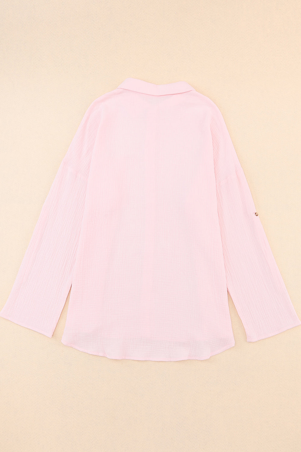 Chemise rose à manches retroussées et texture froissée