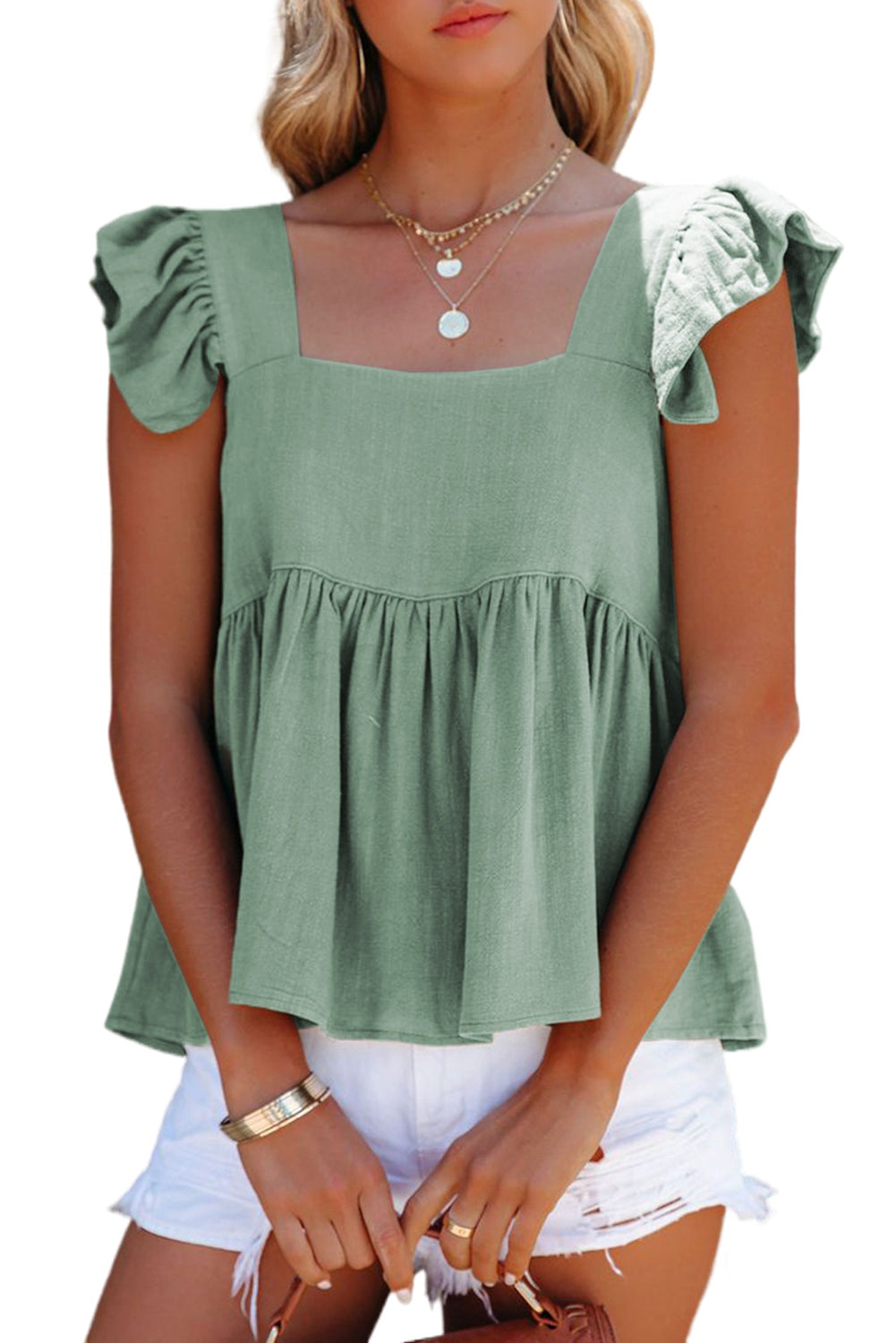 Zelena plapolasta majica Babydoll na ramenih