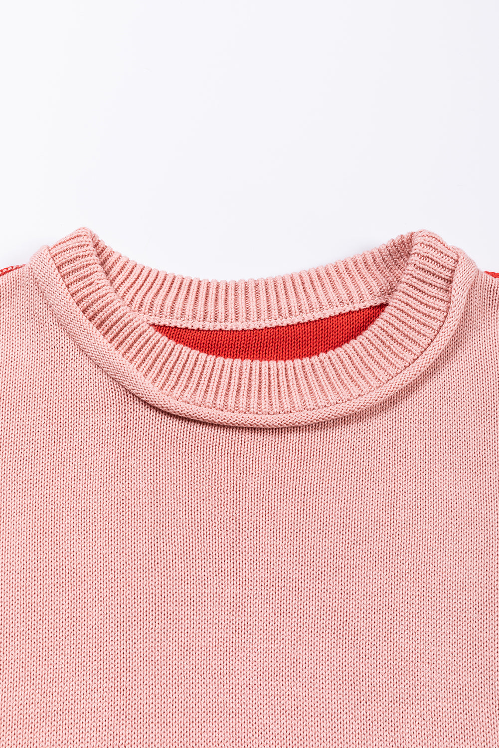 Rožnat pulover z rebrastimi rokavi in ​​barvnimi bloki