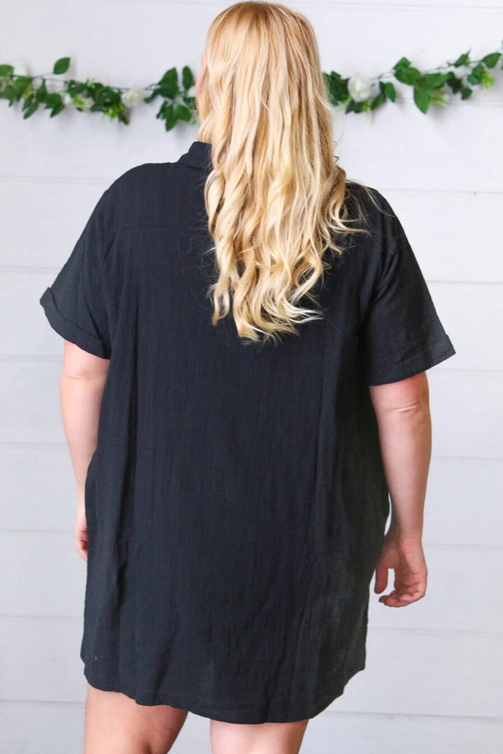 Schwarzes, kurzärmliges Etuikleid mit Hemdkragen und Knöpfen in Übergröße