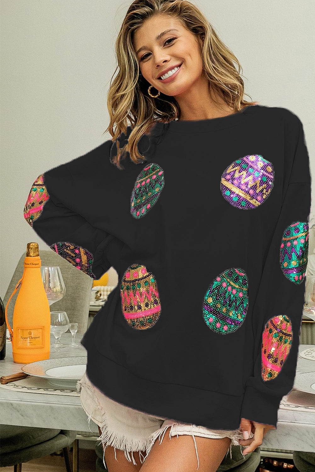 Prevelik pulover s črnim velikonočnim jajcem in spuščenimi rameni