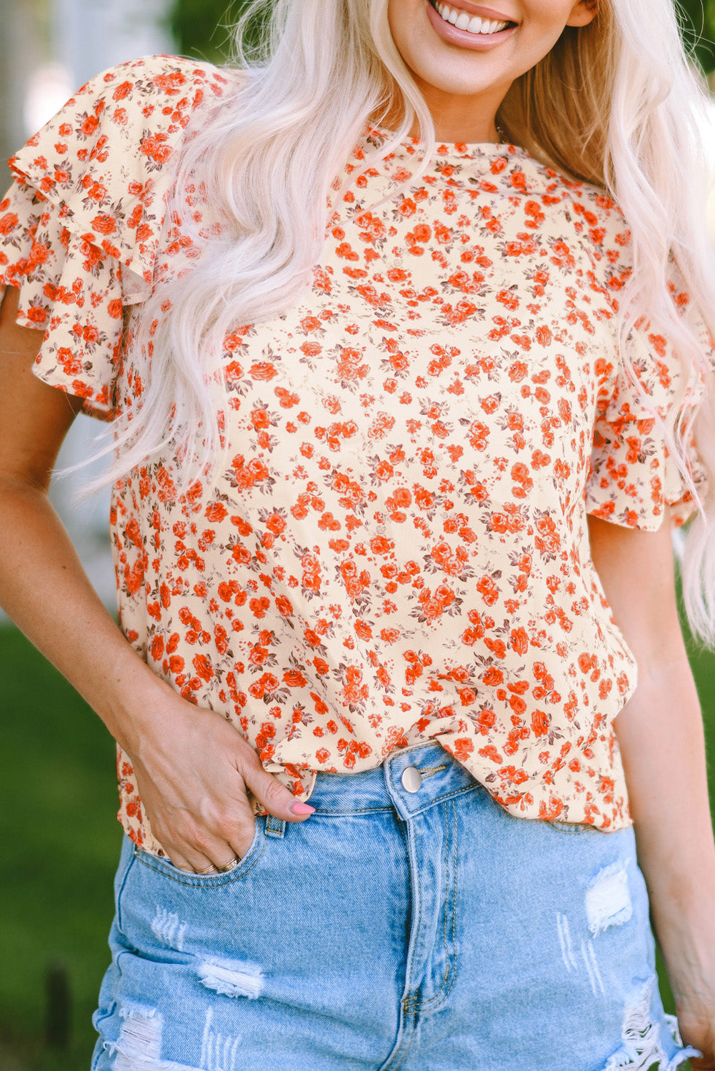 Oranžna bluza s cvetličnimi rokavi v več stopnjah