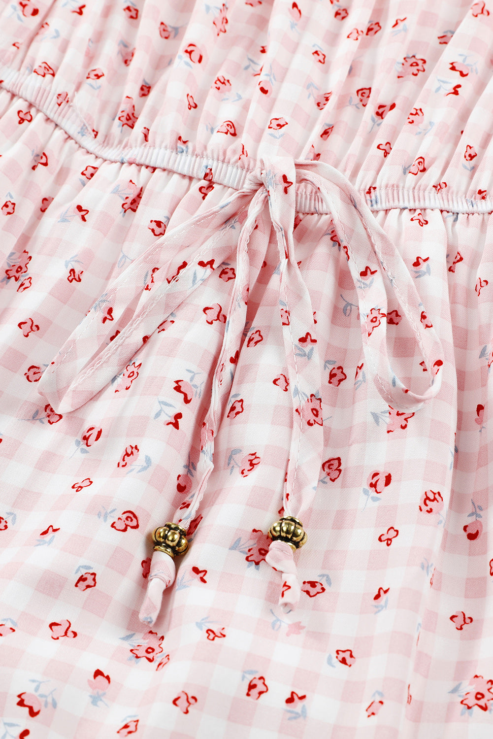 Rožnata cvetlična obleka z naboranim robom in elastičnim pasom