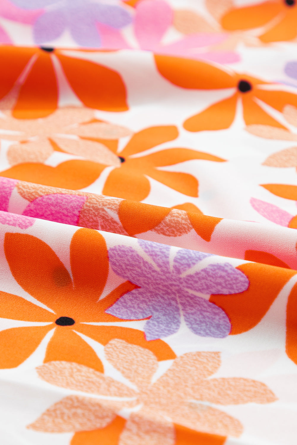 Narančasti top s naboranim rukavima i cvjetnim motivima