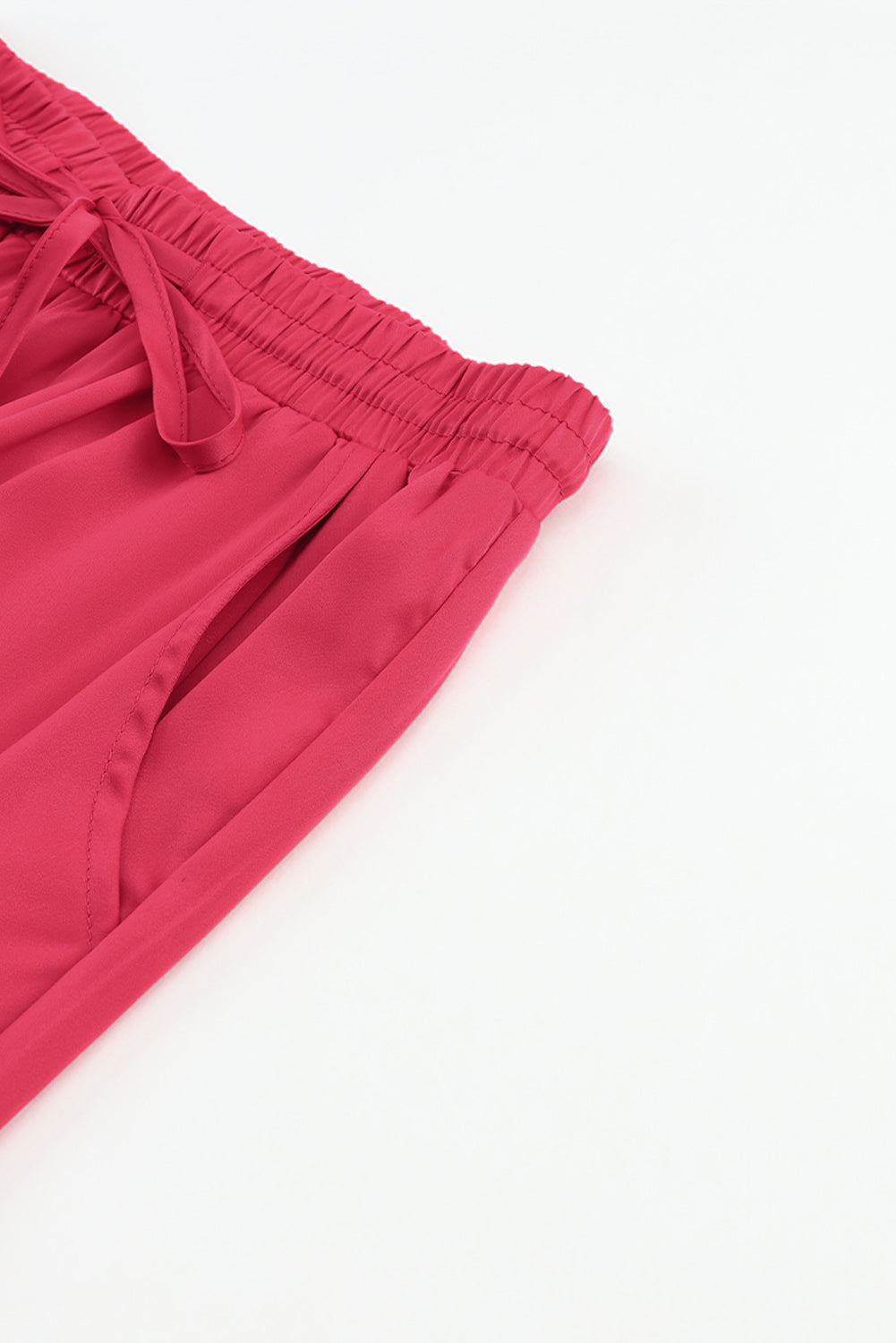 Pantaloni in vita elastica con coulisse e tasca in raso rosa