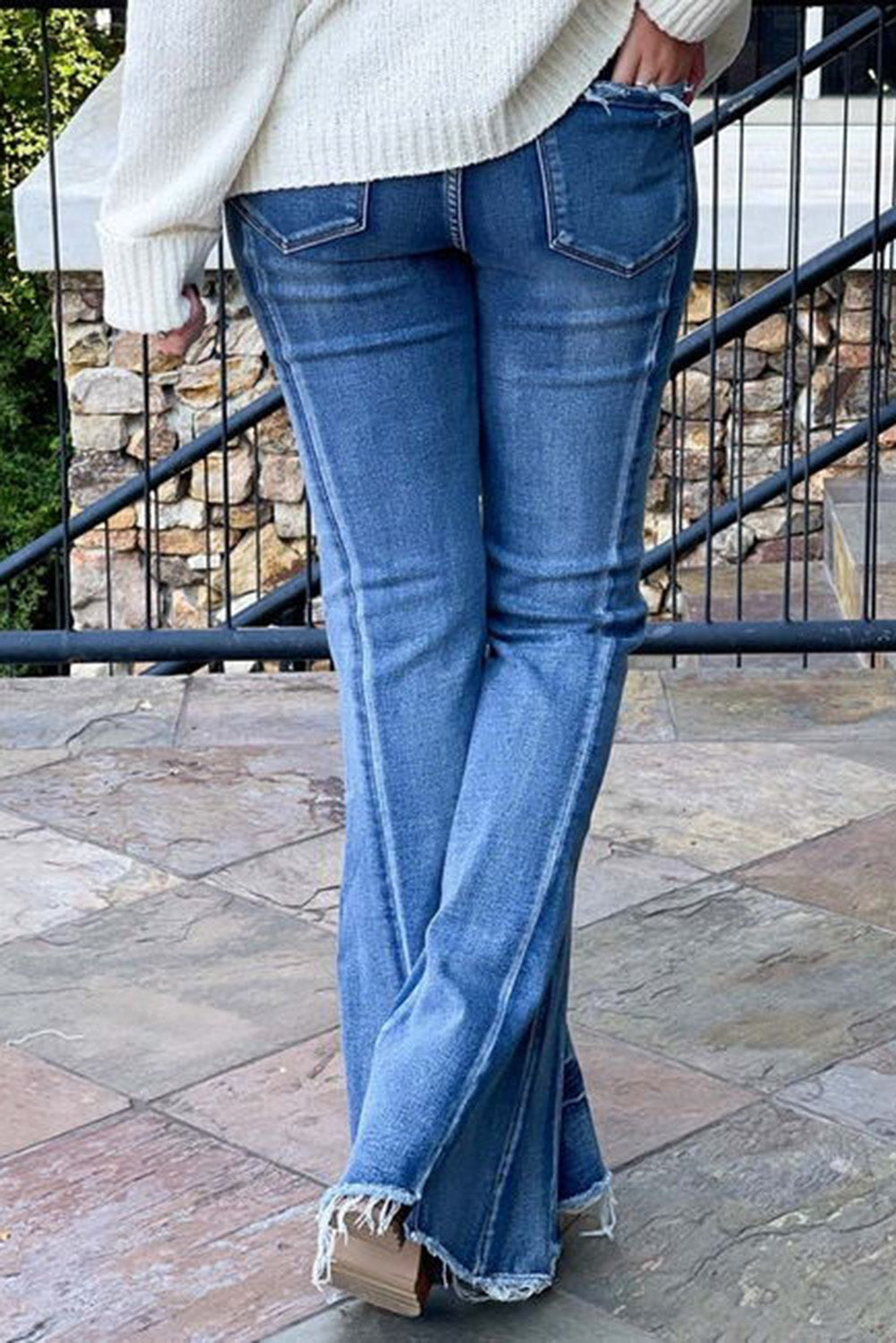 Hellblaue, ausgestellte Jeans mit ungesäumtem Saum und Acid-Waschung