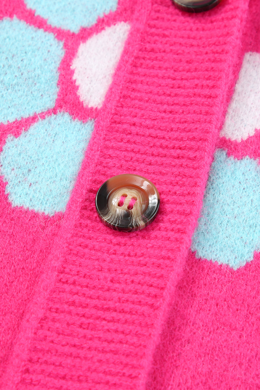 Pletena jopica z gumbi jagodno rožnate barve