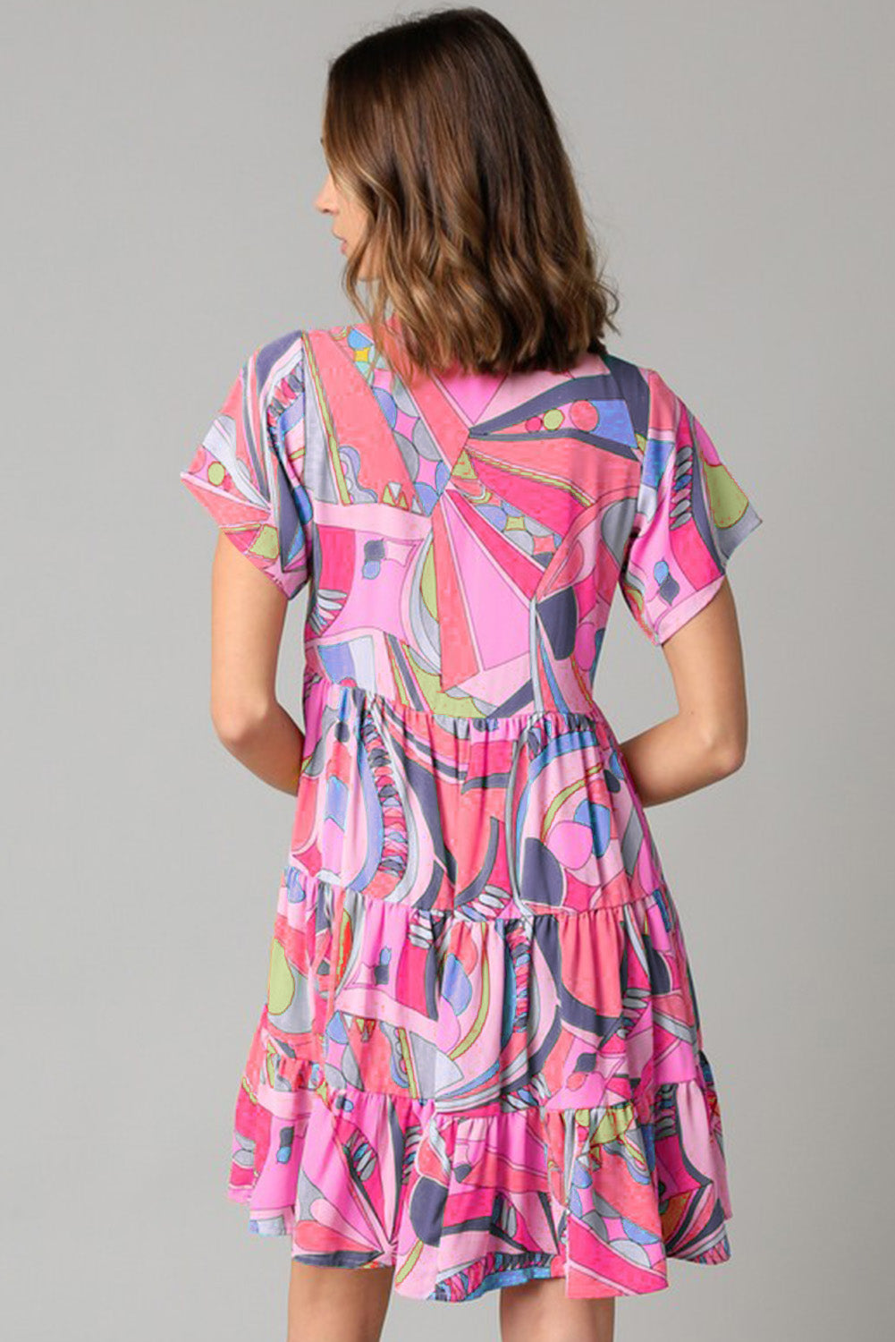 Rosafarbenes, ausgestelltes Kleid mit abstraktem geometrischem Print und Quastenbindung