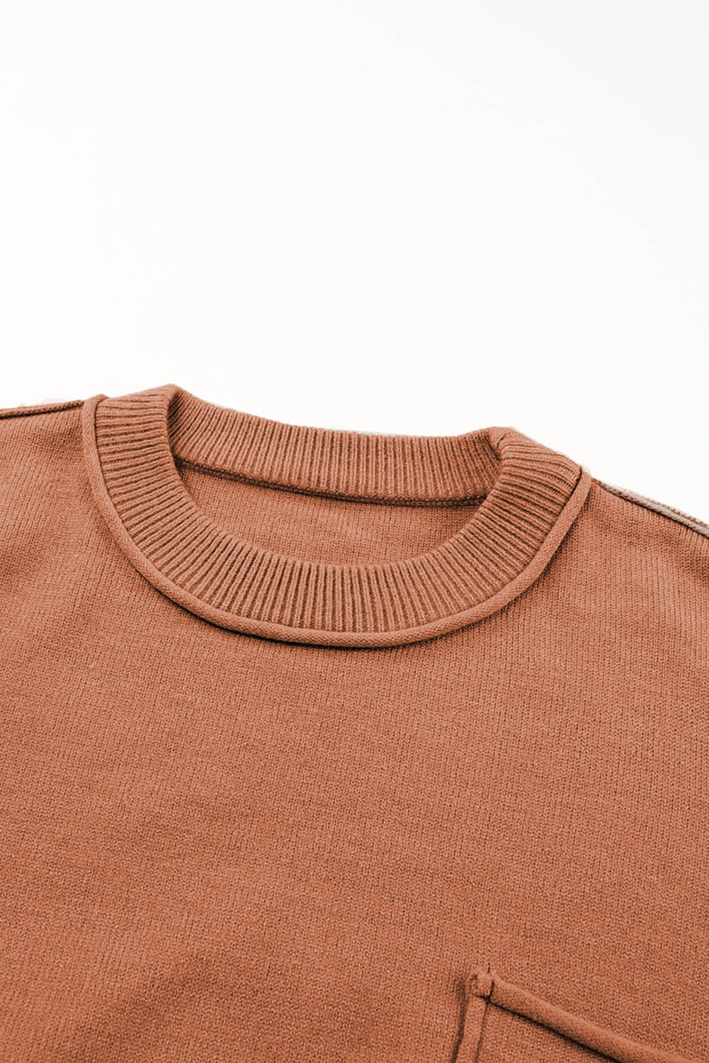 Oranžen ohlapen pulover z neobdelanimi robovi in ​​žepi z izpostavljenimi šivi