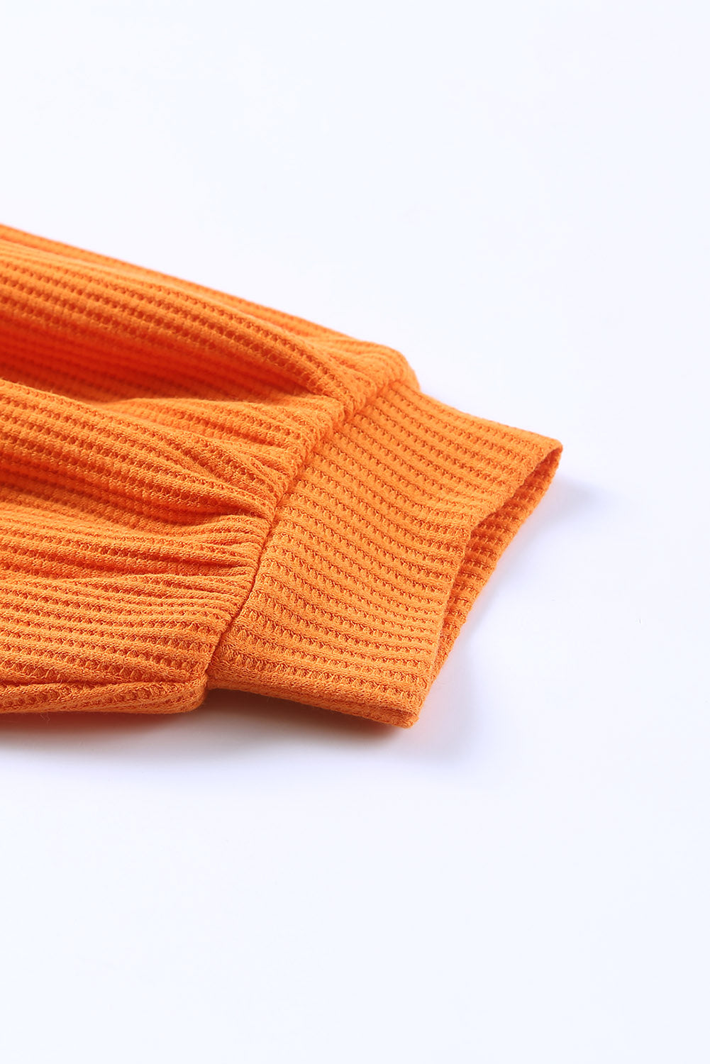 Orangefarbenes, geknöpftes Waffelstrick-Oberteil mit V-Ausschnitt und überschnittener Schulter