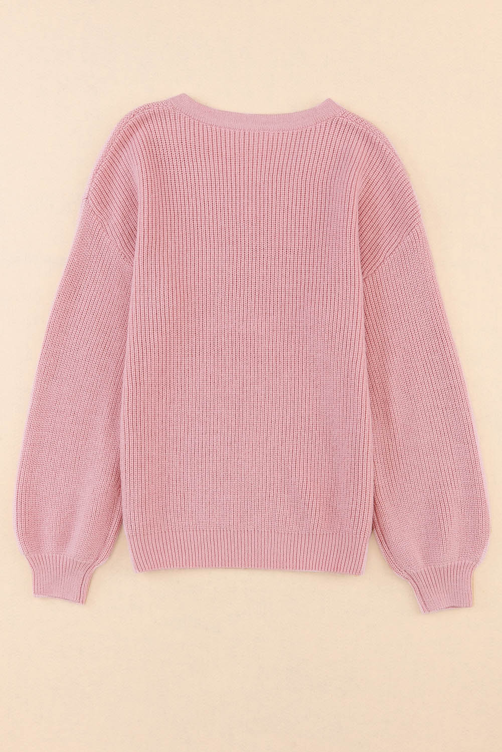 Pull tricoté rose à col en V et épaules tombantes