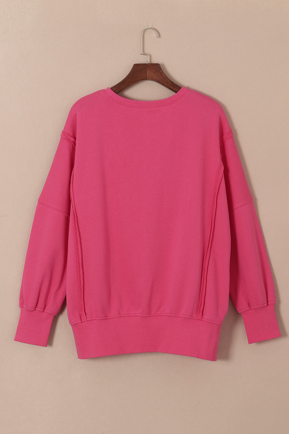 Sweat-shirt rose à coutures apparentes, épaules tombantes, fente, ourlet haut et bas