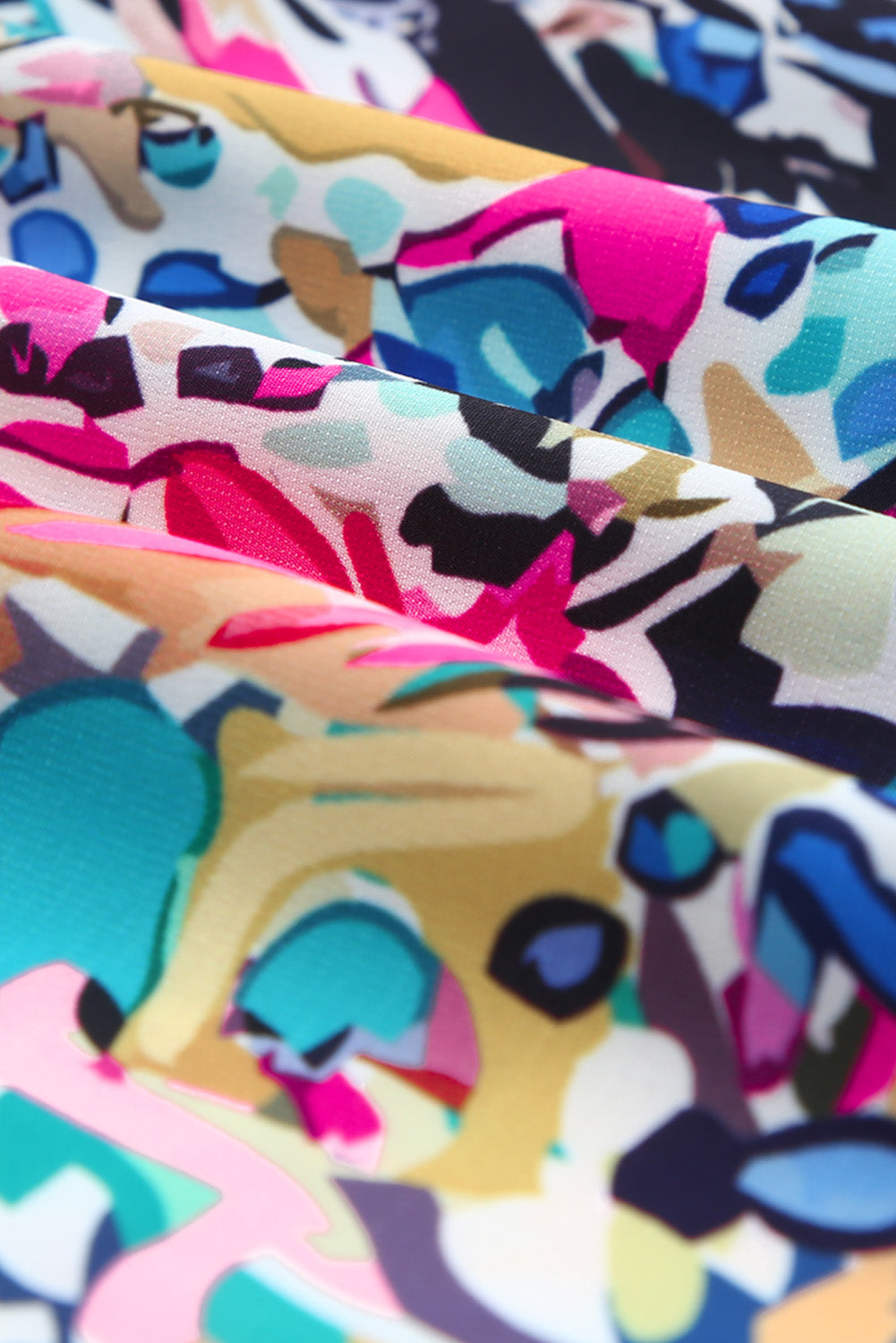 Mehrfarbige Schößchenbluse mit abstraktem Print und V-Ausschnitt zum Binden