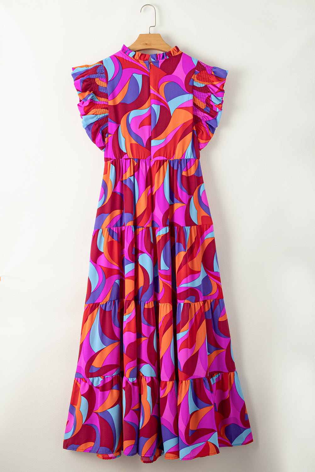 Narančasta dugačka haljina visokog struka s volanima u više slojeva s otisnutim apstraktnim uzorkom