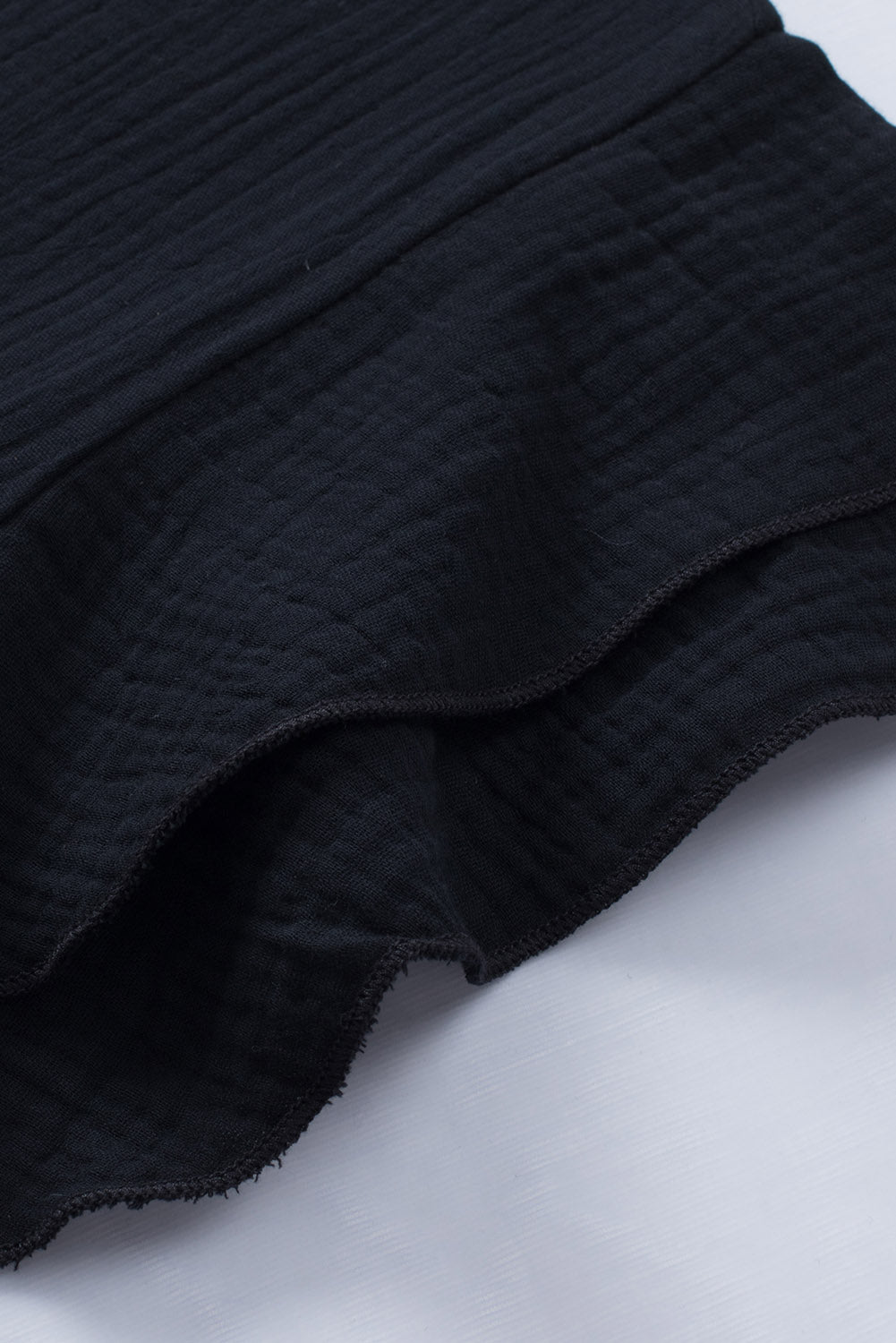 Črna teksturirana bluza s kratkimi rokavi v več stopnjah