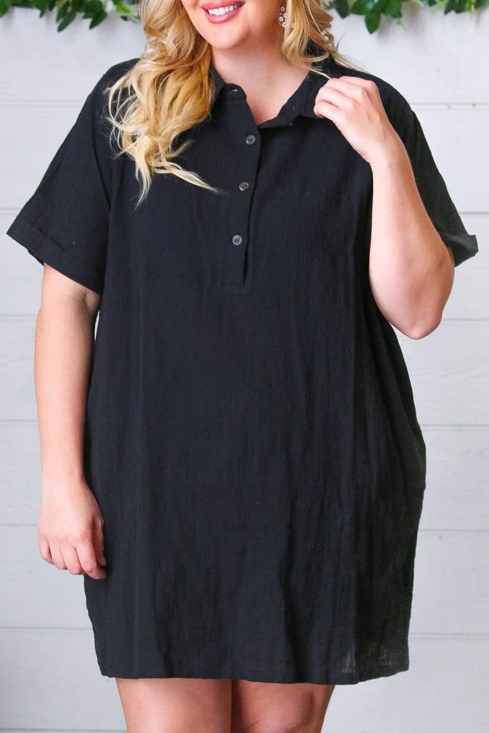 Schwarzes, kurzärmliges Etuikleid mit Hemdkragen und Knöpfen in Übergröße