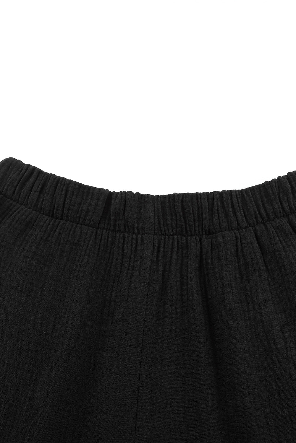 Pantalon noir texturé taille haute à volants et cloche