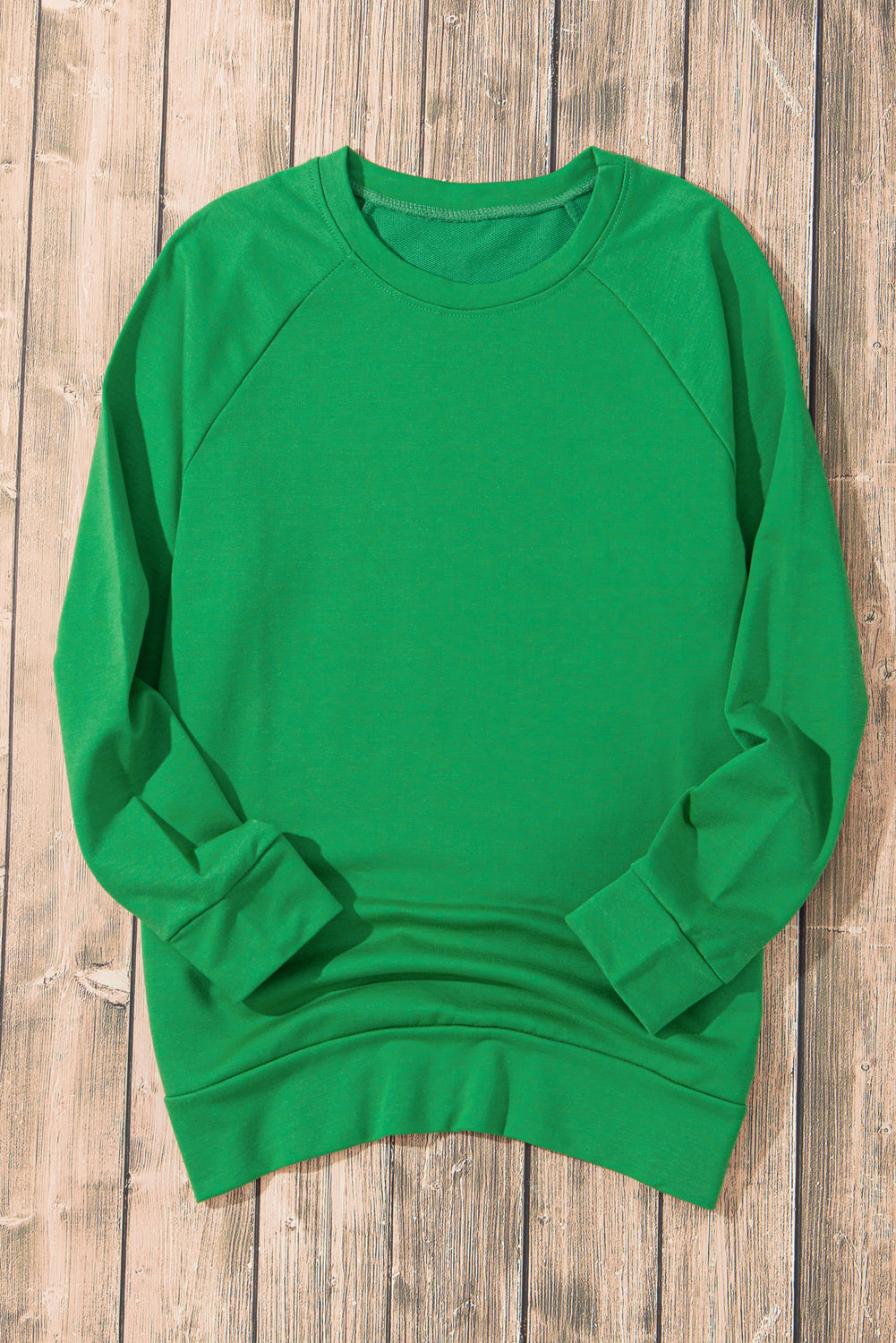 Zelena enobarvna jopica z okroglim ovratnikom in raglan rokavi