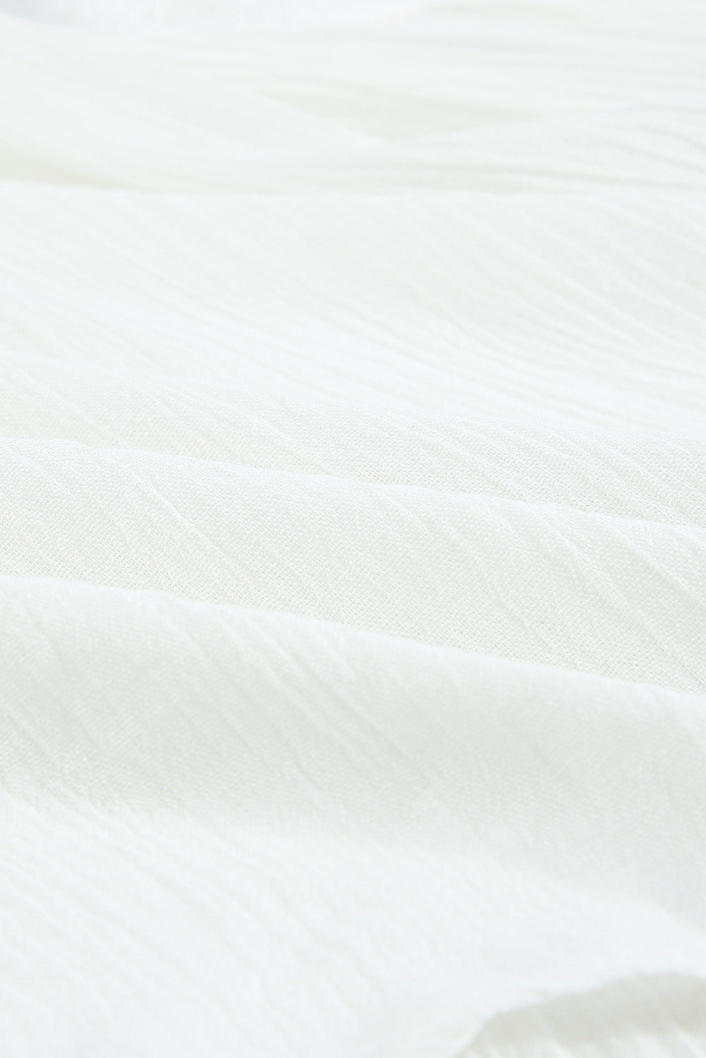 Bela majica z v-izrezom s prepletenimi čipkami in naborki