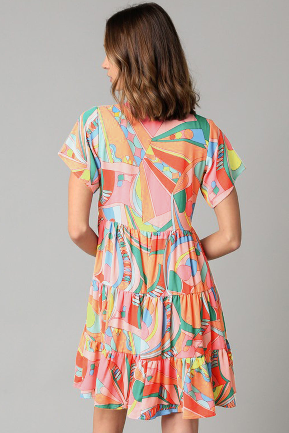 Mehrfarbiges, ausgestelltes Kleid mit abstraktem geometrischem Print und Quastenbindung
