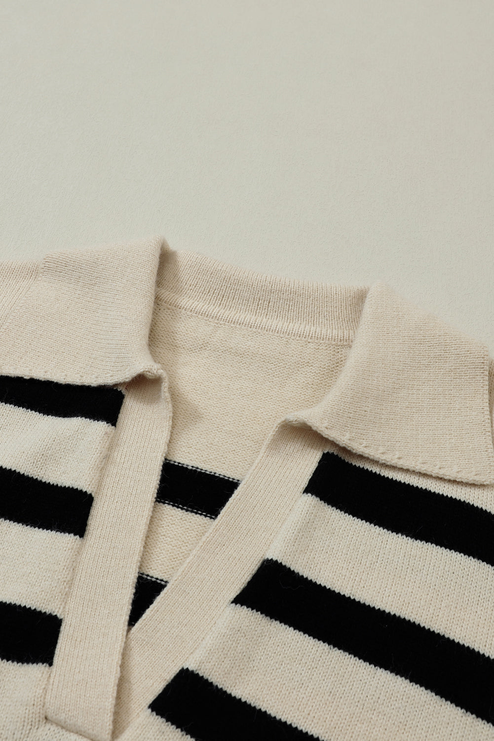 Prugasti pleteni pulover spuštenih ramena i V izrezom boje marelice