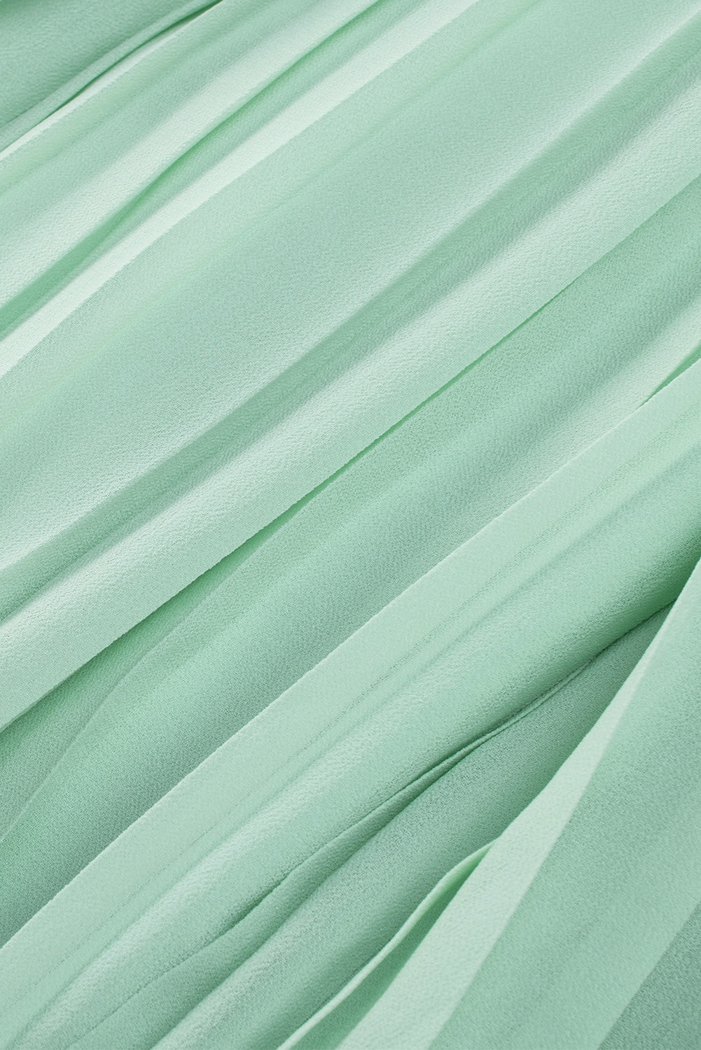 Zeleni plisirani kombinezoni z naborki in gumbi za zavezovanje v izrezu