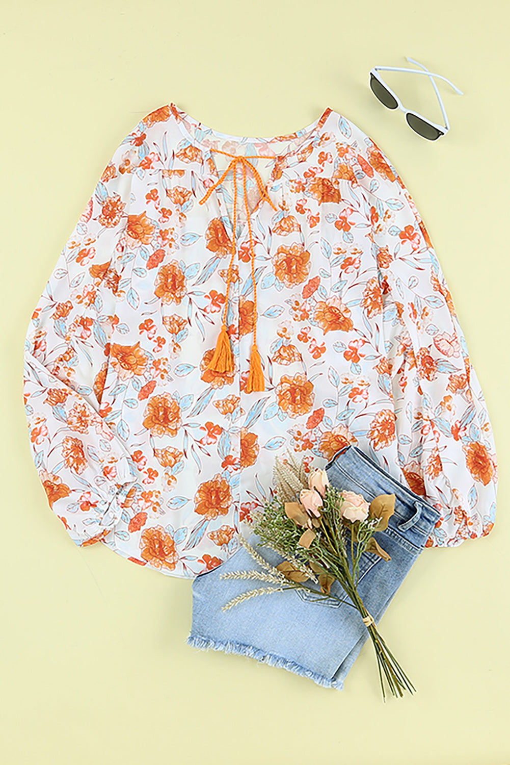 Oranžna dolman bluza s cvetličnim potiskom z v-izrezom