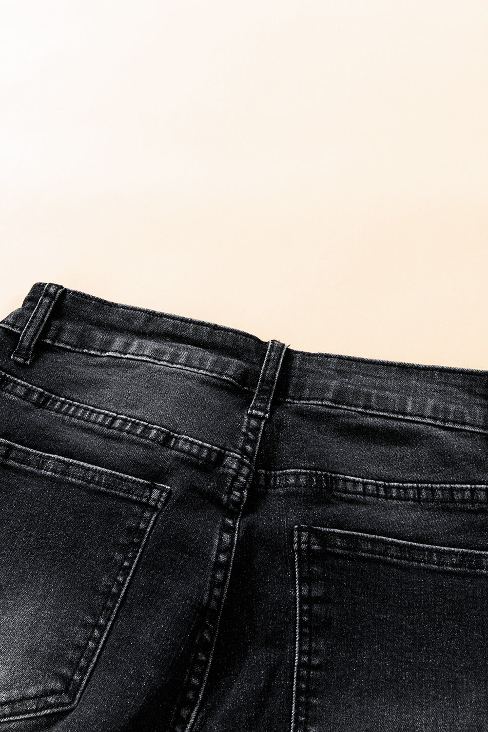 Jeans neri a vita media con bottoni e orlo grezzo invecchiato