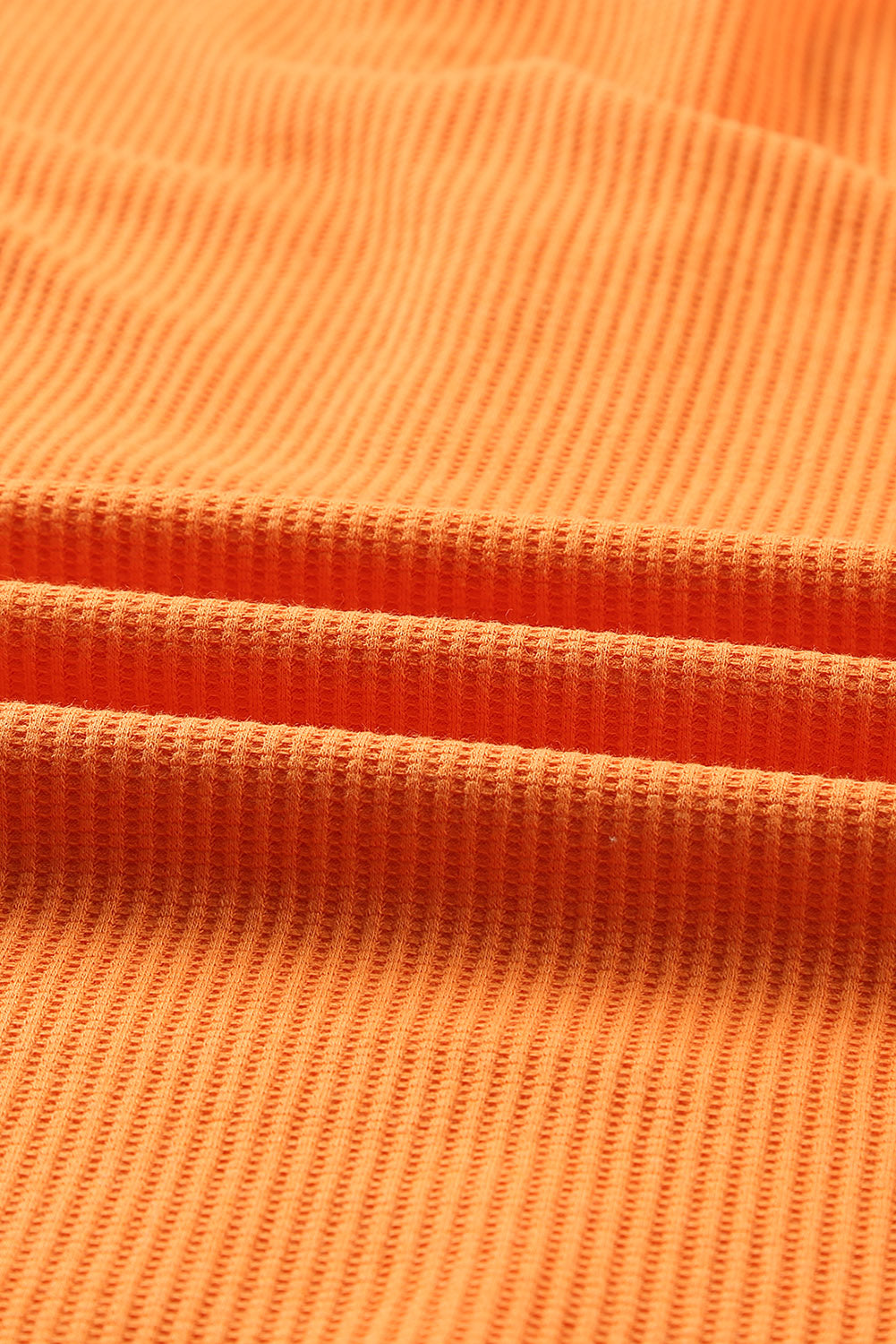 Oranžna pletena majica z vafeljskimi gumbi in z v-izrezom