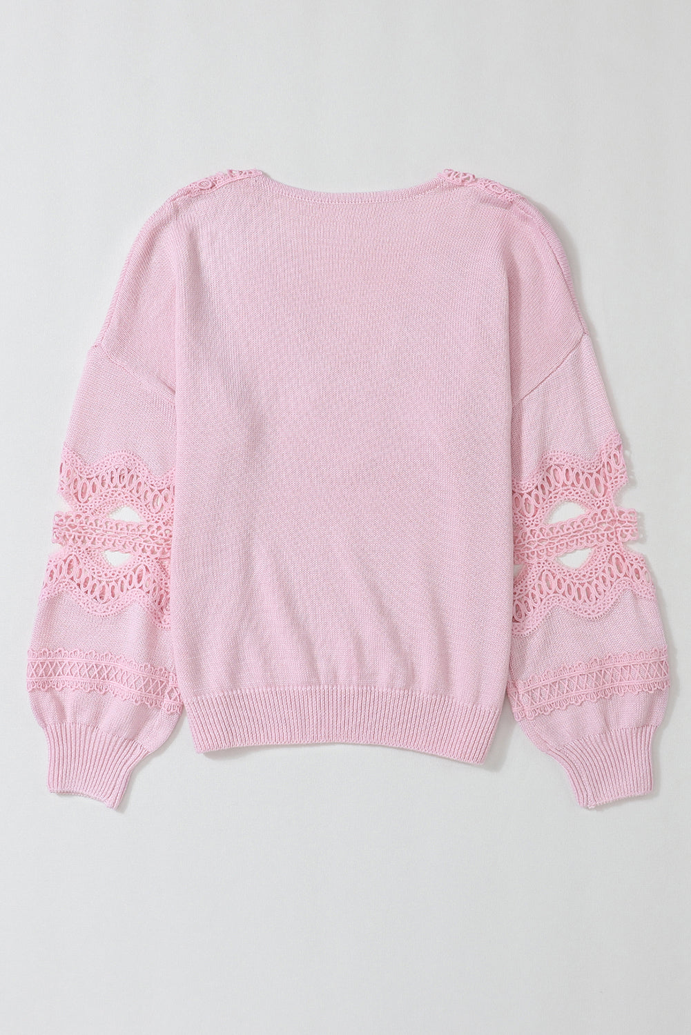 Rožnat ohlapen pulover z vdolbljenim čipkastim v izrezom